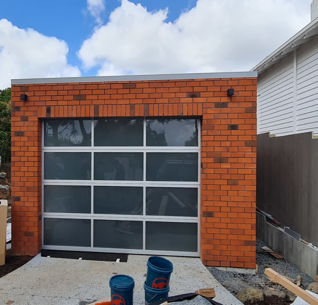 Glass Garage Door on brick home